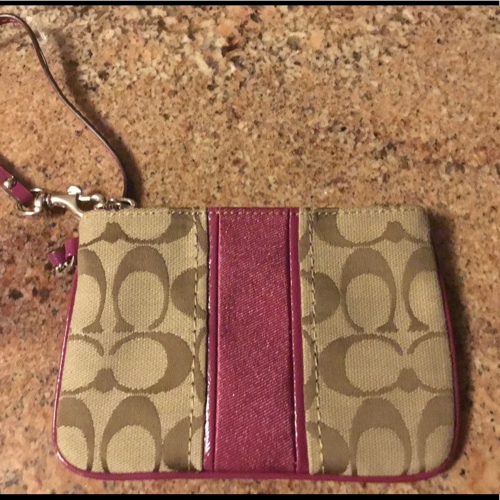 Coach wristlet with pink band